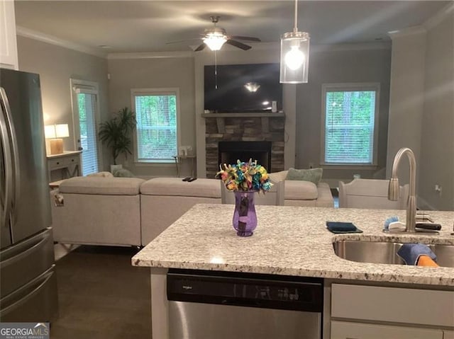 100 Ruby Ln, Mcdonough, GA 30252 - kitchen featuring stainless steel appliances, open floor plan, a sink, white cabinets, and crown molding