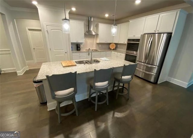 100 Ruby Ln, Mcdonough, GA 30252 - kitchen featuring a sink, stainless steel appliances, wall chimney exhaust hood, baseboards, and white cabinets