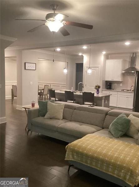 100 Ruby Ln, Mcdonough, GA 30252 - living room featuring ceiling fan, dark wood-style floors, ornamental molding, and baseboards