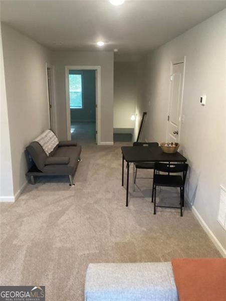 100 Ruby Ln, Mcdonough, GA 30252 - living area with light carpet and baseboards