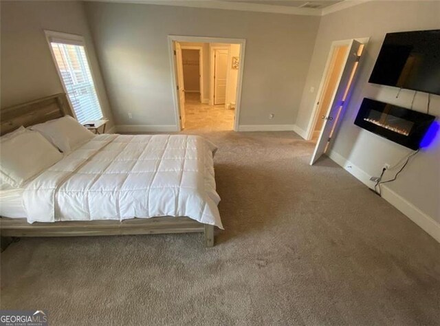 100 Ruby Ln, Mcdonough, GA 30252 - carpeted bedroom with ornamental molding, a glass covered fireplace, and baseboards