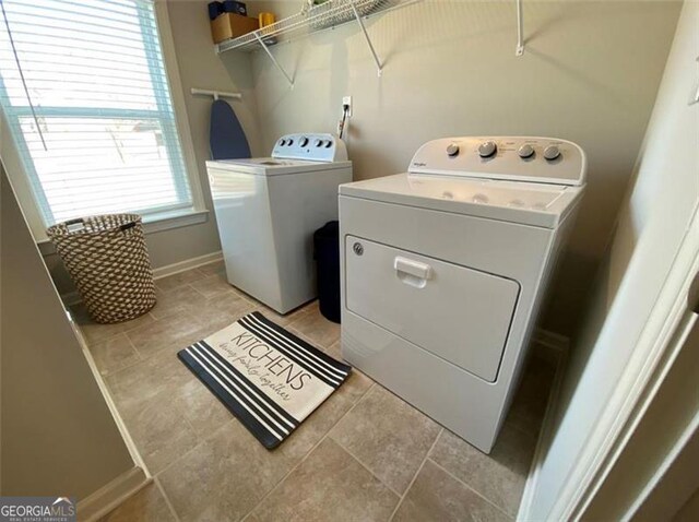 100 Ruby Ln, Mcdonough, GA 30252 - clothes washing area with washing machine and clothes dryer, light tile patterned floors, and baseboards
