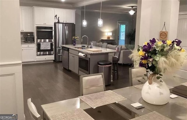 100 Ruby Ln, Mcdonough, GA 30252 - kitchen featuring a sink, stainless steel appliances, white cabinets, pendant lighting, and ceiling fan