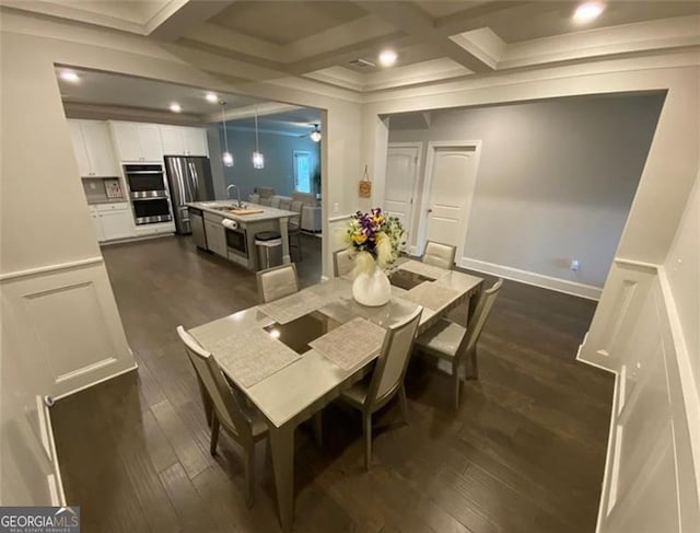 100 Ruby Ln, Mcdonough, GA 30252 - dining space with dark wood-type flooring, beam ceiling, coffered ceiling, and crown molding