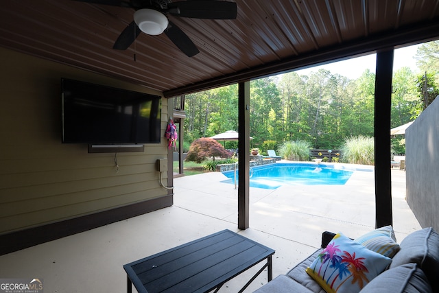 pool with a patio area and a ceiling fan