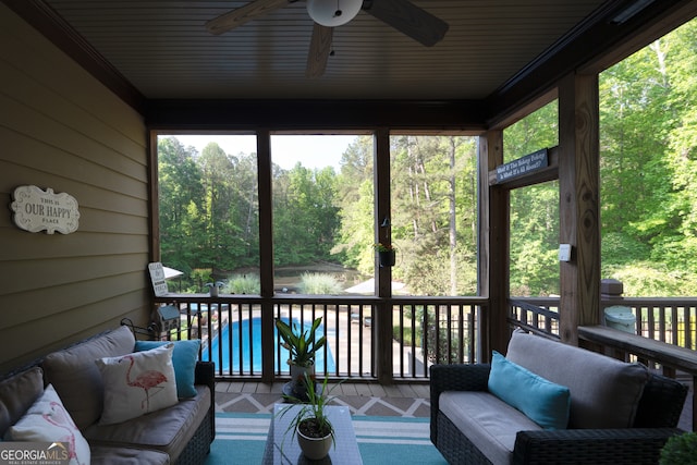 sunroom / solarium with a wealth of natural light, a ceiling fan, and an outdoor living space