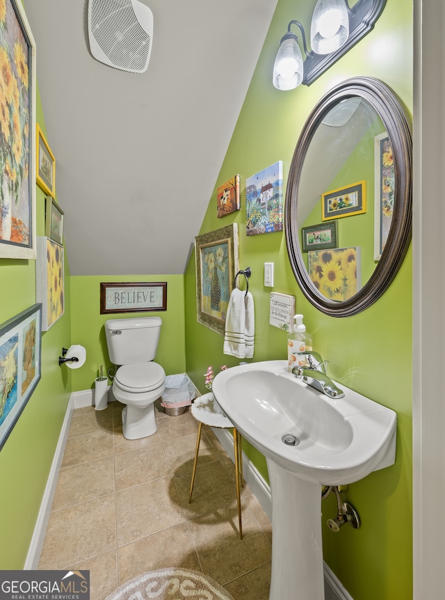 bathroom featuring toilet, visible vents, tile patterned floors, vaulted ceiling, and baseboards