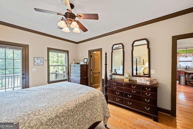 bedroom featuring light wood-style flooring, multiple windows, and access to exterior