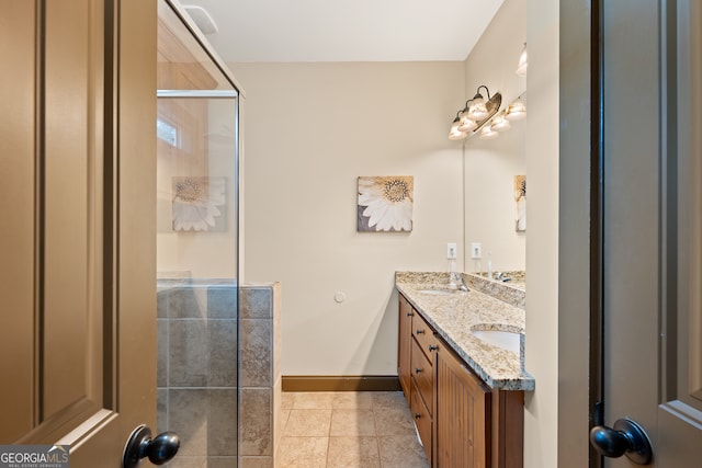 full bathroom featuring baseboards, an enclosed shower, tile patterned flooring, and vanity