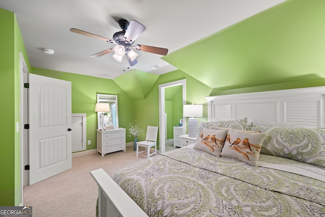 bedroom featuring visible vents, vaulted ceiling, ceiling fan, carpet floors, and baseboards
