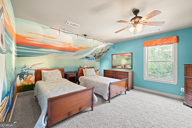 carpeted bedroom with baseboards, ceiling fan, visible vents, and track lighting