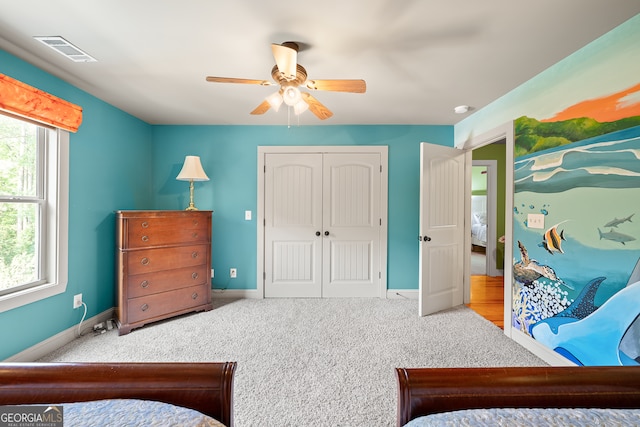 bedroom with baseboards, a closet, visible vents, and carpet