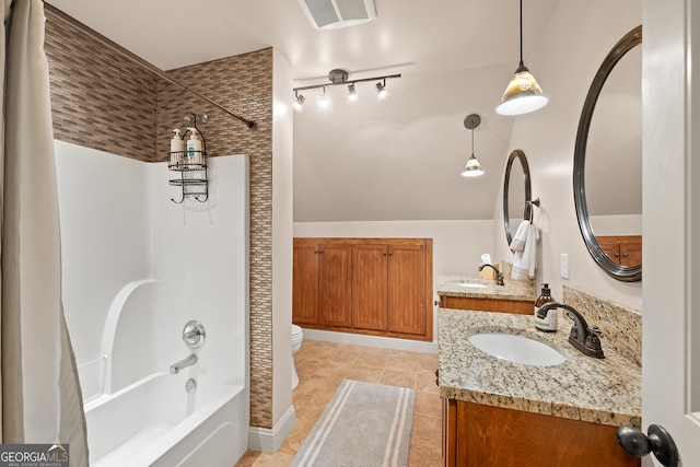 full bath featuring a sink, double vanity, toilet, and visible vents