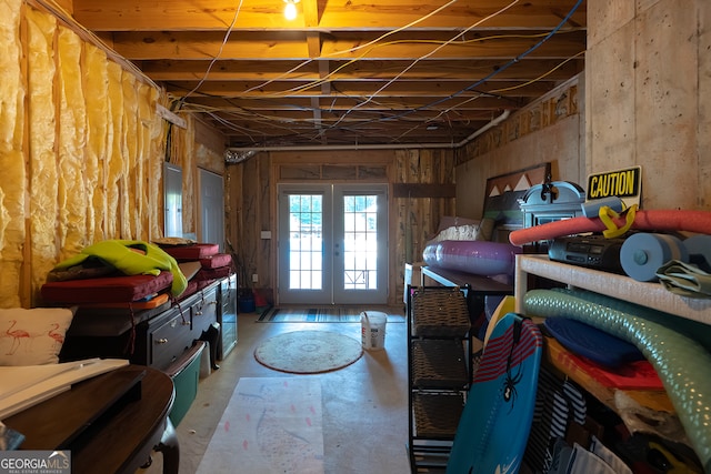 below grade area featuring electric panel and french doors
