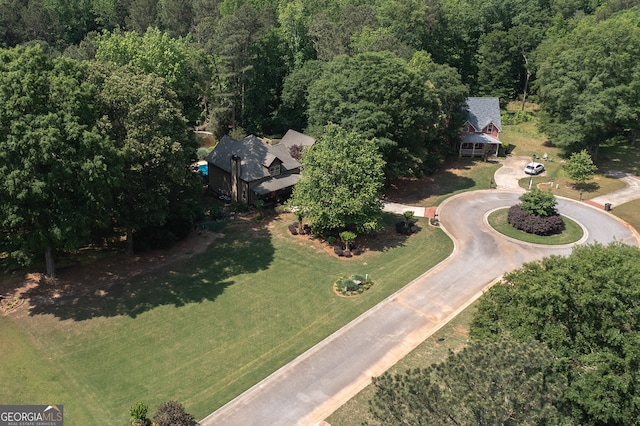 bird's eye view with a wooded view