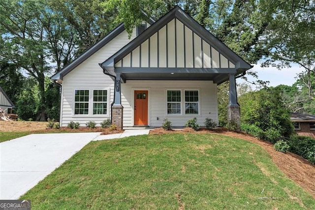 2621 Oldknow Dr NW, Atlanta, GA 30318 - view of front facade with a front lawn, board and batten siding, and covered porch