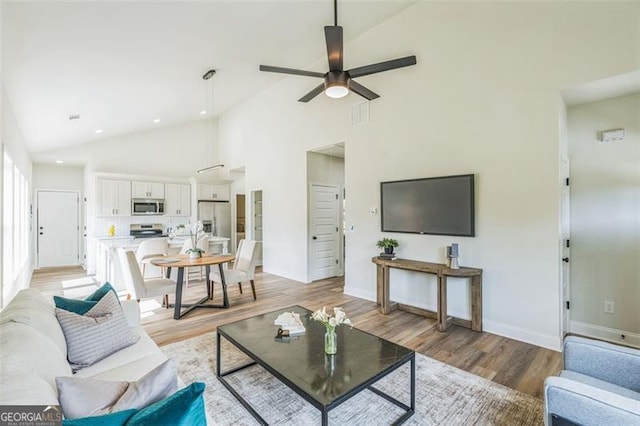 2621 Oldknow Dr NW, Atlanta, GA 30318 - living area featuring ceiling fan, recessed lighting, high vaulted ceiling, and light wood-style floors