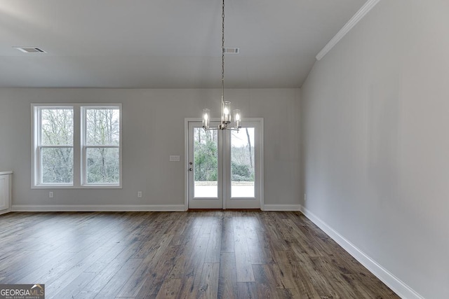 unfurnished dining area featuring a wealth of natural light, visible vents, dark wood-type flooring, and a notable chandelier