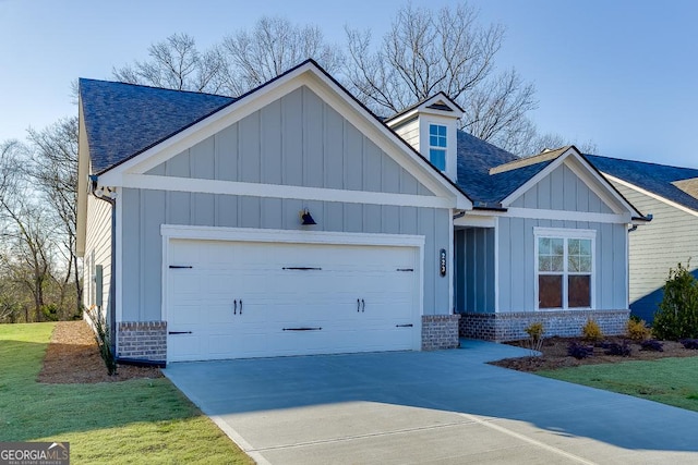 view of front of property with an attached garage, brick siding, driveway, board and batten siding, and a shingled roof