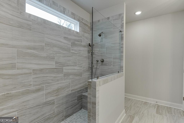 full bath featuring baseboards, walk in shower, and recessed lighting