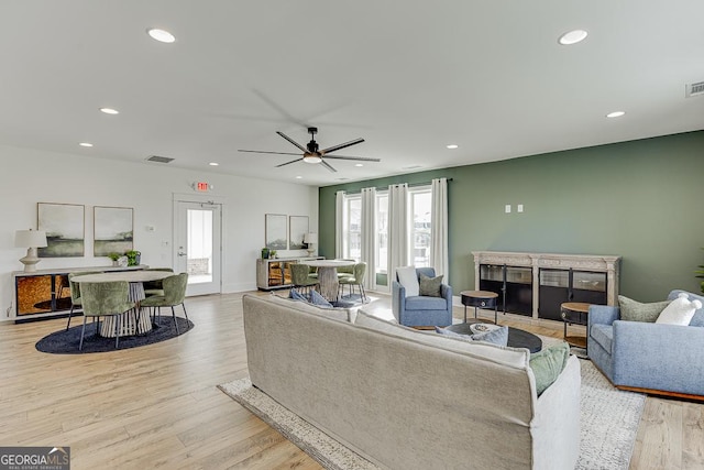 living area with ceiling fan, light wood-style flooring, visible vents, and recessed lighting