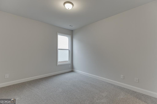 carpeted empty room with baseboards and visible vents