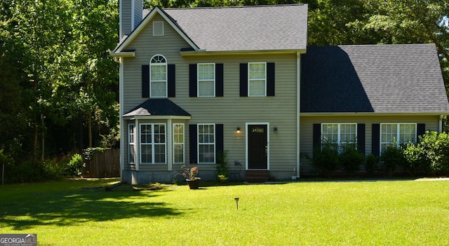 202 Willow Oak Way, Lizella, GA 31052 - colonial home with roof with shingles, fence, a chimney, and a front yard