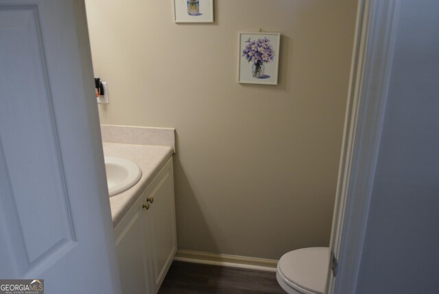 202 Willow Oak Way, Lizella, GA 31052 - half bath featuring vanity, toilet, baseboards, and wood finished floors
