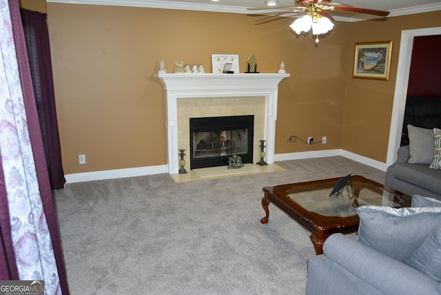 carpeted living area featuring a ceiling fan, a fireplace with flush hearth, crown molding, and baseboards