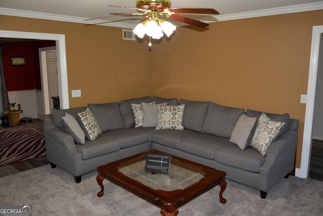 living area featuring ceiling fan, crown molding, carpet floors, and visible vents