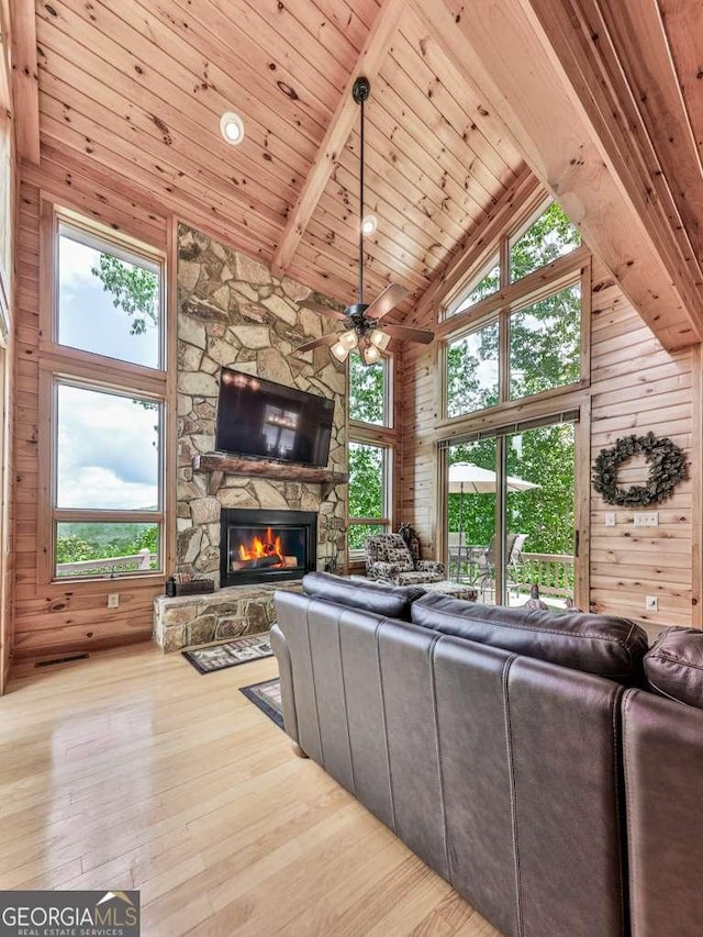 550 My Mountain Rd, Morganton, GA 30560 - living room featuring high vaulted ceiling, hardwood / wood-style flooring, a ceiling fan, a stone fireplace, and healthy amount of natural light