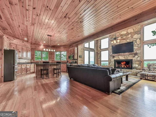 550 My Mountain Rd, Morganton, GA 30560 - living area with a stone fireplace, light wood-style flooring, ceiling fan, and wooden ceiling