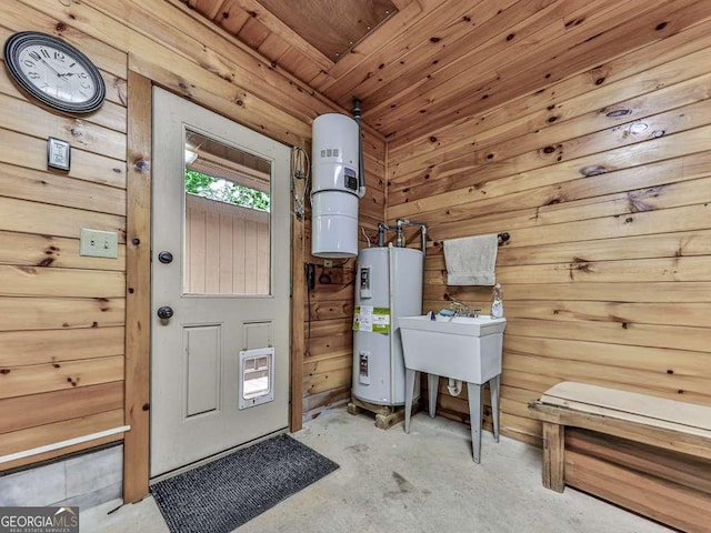 550 My Mountain Rd, Morganton, GA 30560 - misc room with electric water heater, unfinished concrete floors, and wooden walls