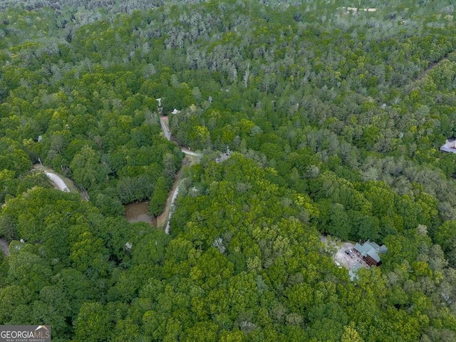 drone / aerial view featuring a wooded view
