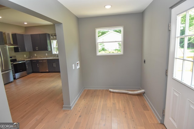 doorway with recessed lighting, baseboards, and light wood-style floors