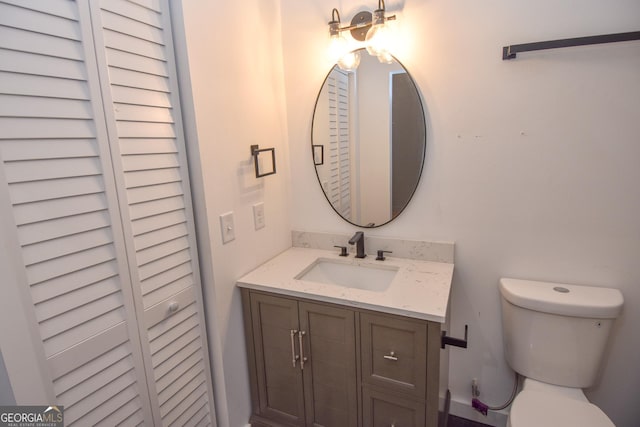 bathroom featuring toilet and vanity