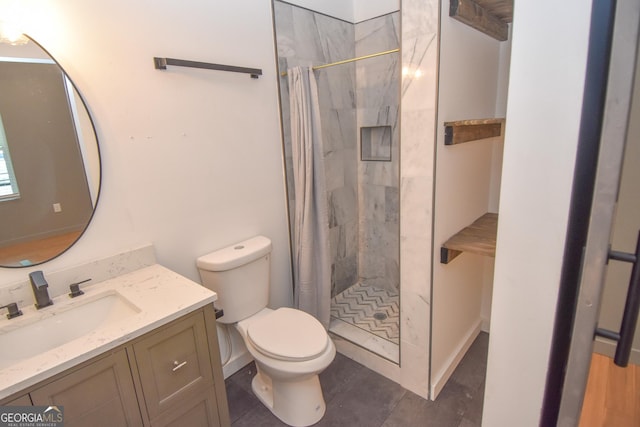 bathroom featuring vanity, toilet, and a tile shower
