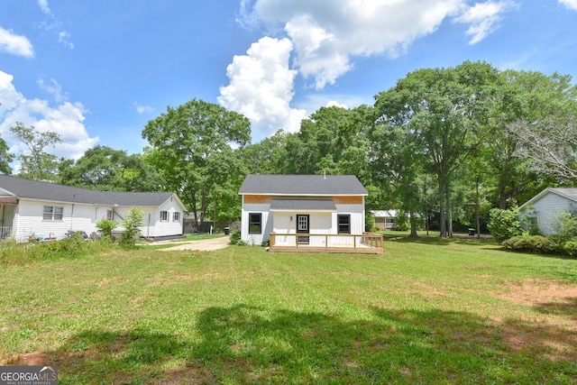 back of house with a yard, a deck, and board and batten siding