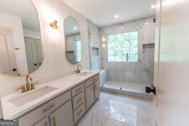 bathroom with walk in shower, double vanity, marble finish floor, and a sink