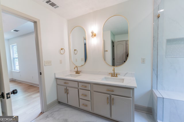 full bath with double vanity, visible vents, and a sink