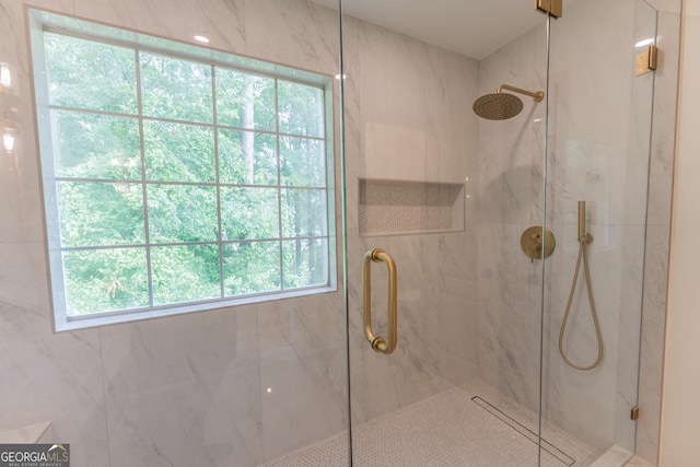 bathroom with a marble finish shower
