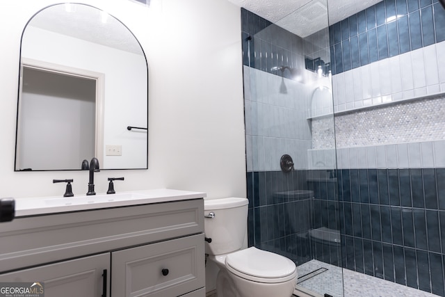 bathroom featuring toilet, walk in shower, and vanity