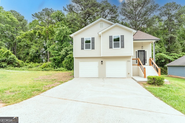 split level home featuring a front lawn, concrete driveway, roof with shingles, and a garage