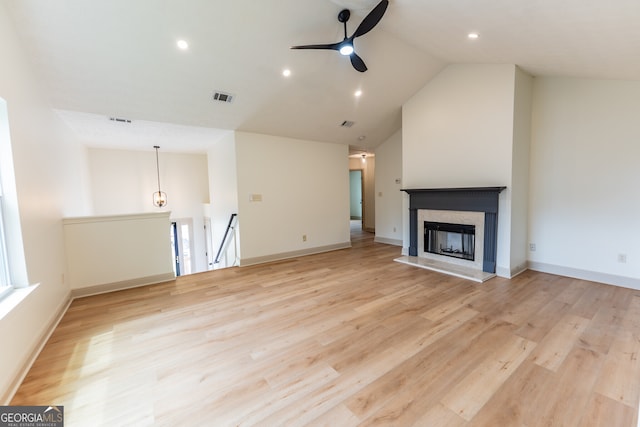 unfurnished living room featuring light wood-type flooring, visible vents, lofted ceiling, and a ceiling fan