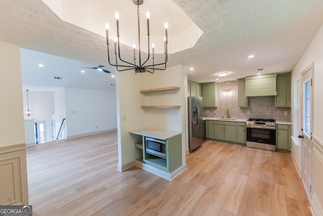 kitchen featuring a chandelier, stainless steel appliances, open shelves, and green cabinetry