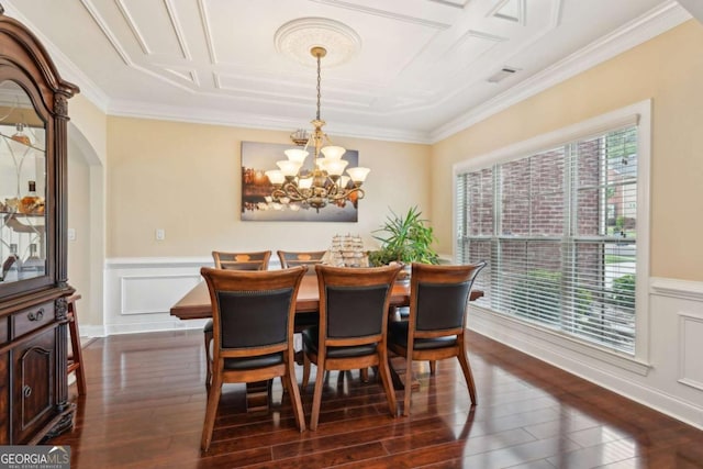 dining area featuring dark wood-style flooring, ornamental molding, and a notable chandelier
