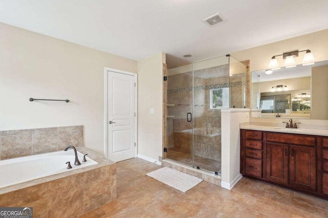 bathroom featuring vanity, baseboards, visible vents, a stall shower, and a garden tub