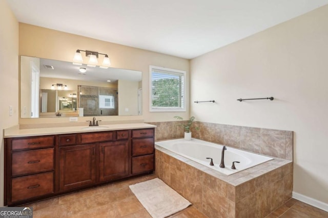 full bathroom featuring a shower stall, tile patterned flooring, a garden tub, and vanity