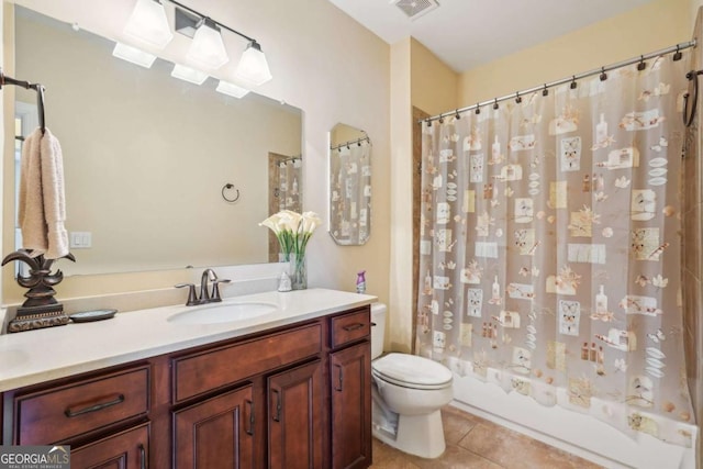 bathroom featuring toilet, vanity, visible vents, tile patterned floors, and shower / bath combination with curtain