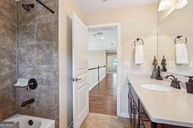 bathroom featuring tile patterned floors, bathing tub / shower combination, baseboards, and vanity
